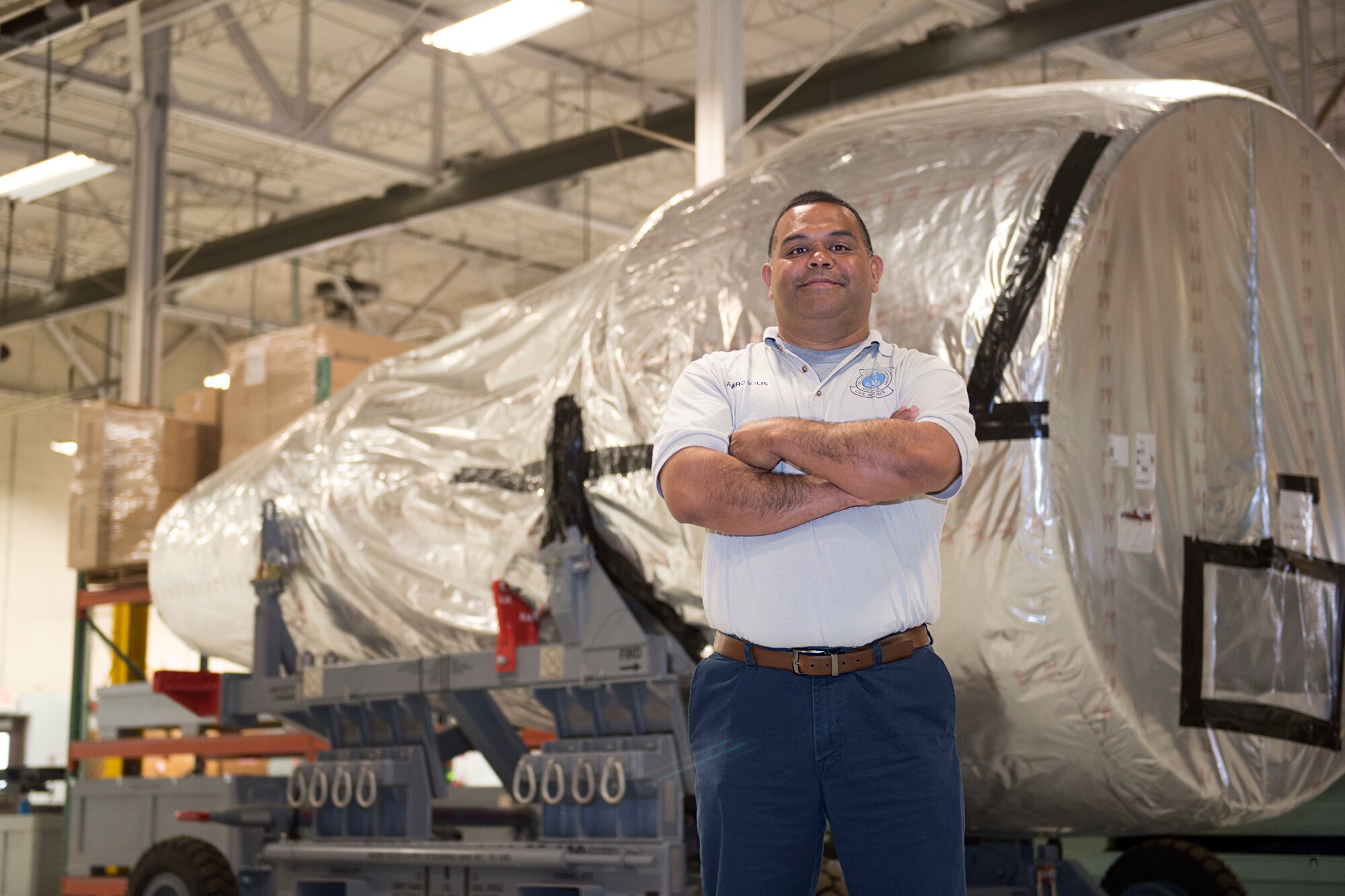 Ramiro Solis, the KC-46 Pegasus programs manager assigned to the 97th Aircraft Maintenance Squadron, stands next to a KC-46 engine, April 20, 2018, at Altus Air Force Base, Okla.