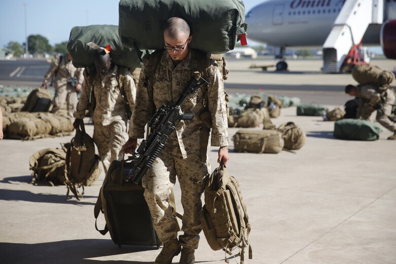 U.S. Marines and Sailors with Marine Rotational Force – Darwin 2018 collect their luggage and proceed to customs after arriving at the Royal Australian Air Force Base Darwin, Australia.
