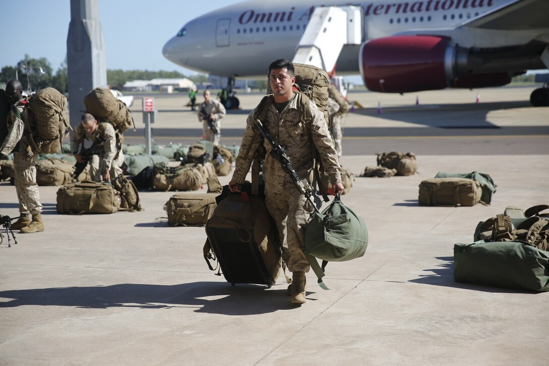 U.S. Marines and Sailors with Marine Rotational Force – Darwin 2018 collect their luggage and proceed to customs after arriving at the Royal Australian Air Force Base Darwin, Australia.