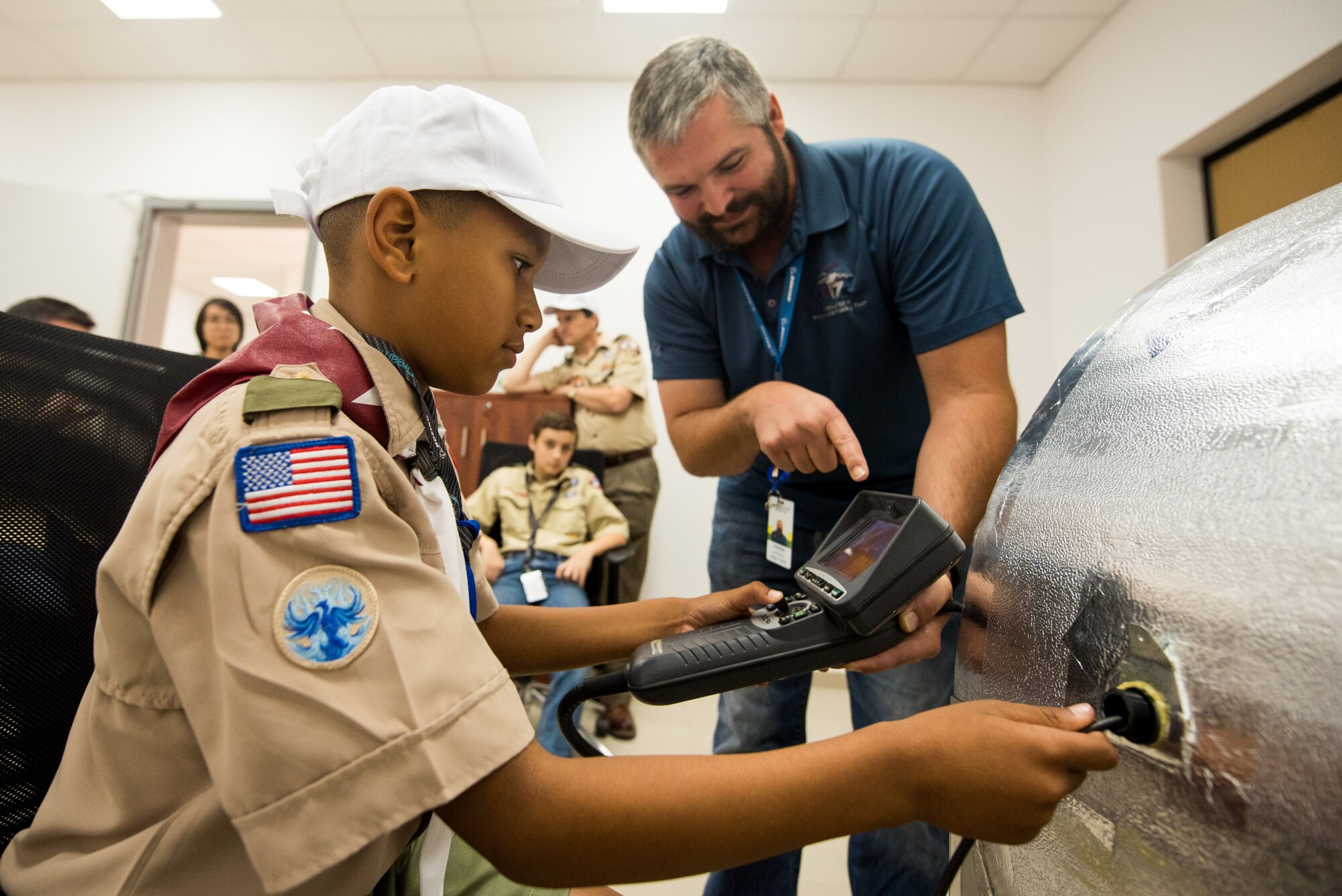 A Boy Scout utilizes a borescope during a tour of Al Udeid Air Base, Qatar, April 20, 2018. The two-day visit, which was collaboratively coordinated by the 379th Air Expeditionary Wing and Qatar Emiri Air Force, provided the scouts a chance to earn merit badges, including the Aviation Merit Badge. (U.S. Air Force photo by Staff Sgt. Joshua Horton)