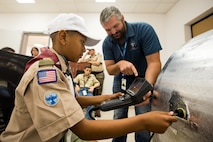 A Boy Scout utilizes a borescope during a tour of Al Udeid Air Base, Qatar, April 20, 2018. The two-day visit, which was collaboratively coordinated by the 379th Air Expeditionary Wing and Qatar Emiri Air Force, provided the scouts a chance to earn merit badges, including the Aviation Merit Badge. (U.S. Air Force photo by Staff Sgt. Joshua Horton)