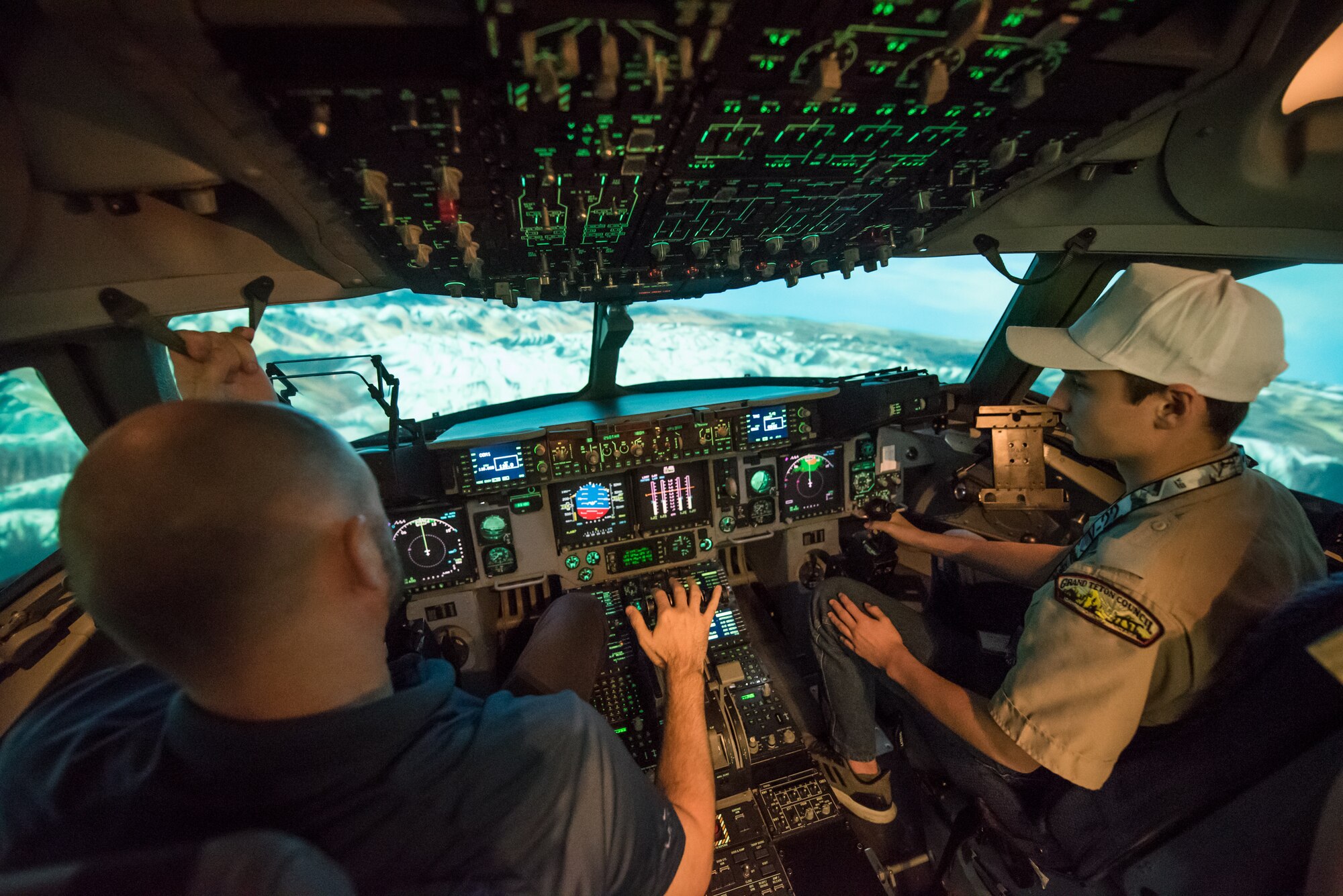 A Boy Scout utilizes a C-17 Globemaster III aircraft flight simulator during a tour of Al Udeid Air Base, Qatar, April 20, 2018. The two-day visit, which was collaboratively coordinated by the 379th Air Expeditionary Wing and Qatar Emiri Air Force, provided the scouts a chance to earn merit badges, including the Aviation Merit Badge. (U.S. Air Force photo by Staff Sgt. Joshua Horton)