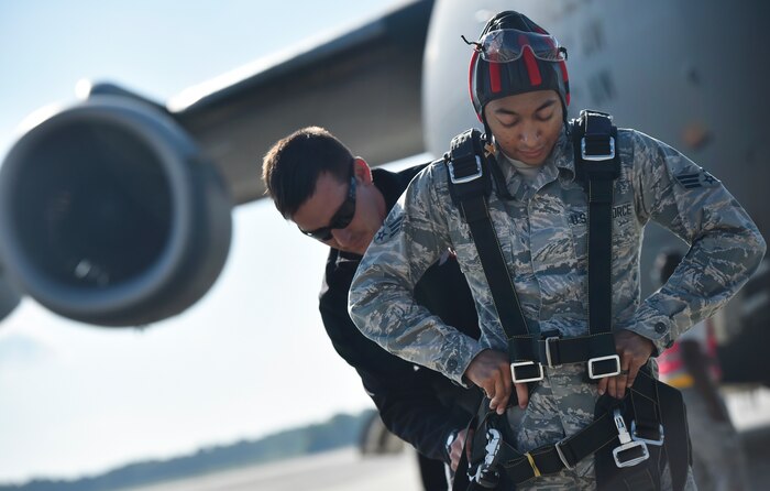U.S. Army Sgt. 1st Class Sean O’Toole, U.S. Army Special Operations Command Parachute Demonstration Team, known as the “Black Daggers,” fastens harness equipment to U.S. Air Force Senior Airman Keyren King, 628th Communications Squadron, prior to performing a practice tandem jump as part of a 2018 Air and Space Expo rehearsal April 27, 2018, at Joint Base Charleston, S.C.