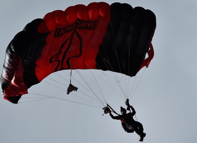 A Soldier from the U.S. Army Special Operations Command Parachute Demonstration Team, known as the “Black Daggers,” parachutes down to a drop zone as part of a 2018 Air and Space Expo rehearsal April 27, 2018, at Joint Base Charleston, S.C.