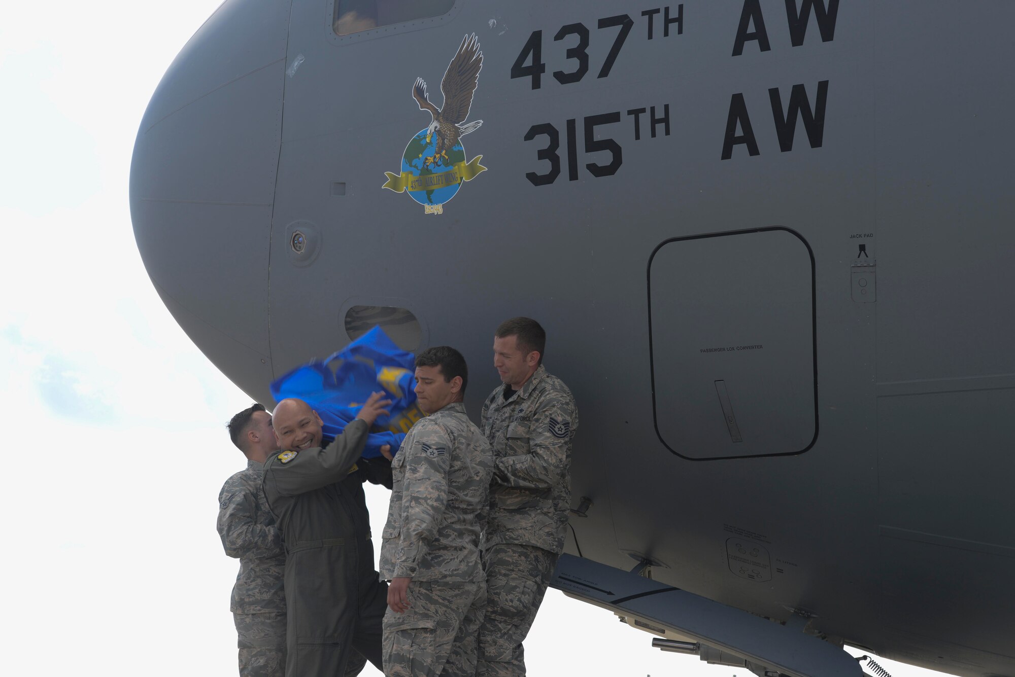 Col. Jimmy Canlas, 437th Airlift Wing commander, and members of the 437th Maintenance Squadron reveal the nose art on a C-17 Globemaster III during rehearsal of the Air and Space Expo, April 27, 2018