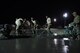 Airmen operate a screed to level cement