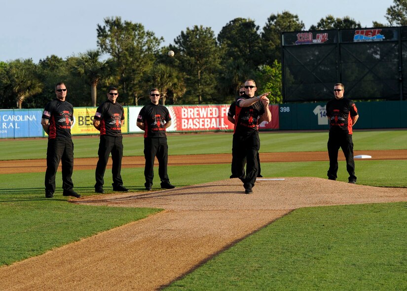 Master Sgt. Christopher Malone, U.S. Army Special Operations Command Black Daggers Parachute Demonstration Detachment demonstrator, throws a ceremonial first pitch at a Joseph P. Riley, Jr. Park during a Charleston RiverDogs baseball game, April 26, 2018.