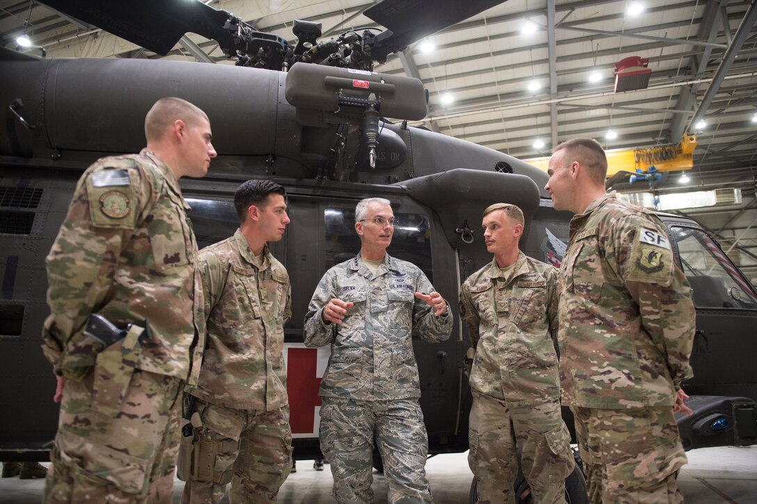 Air Force Gen. Paul J. Selva, vice chairman of the Joint Chiefs of Staff speaks to airmen next to a helicopter.