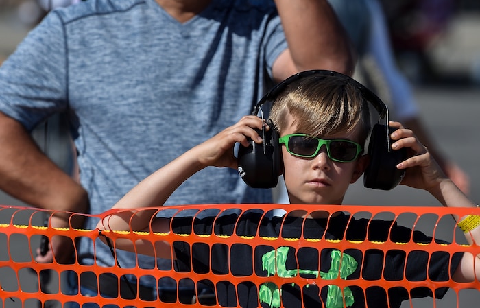 A spectator at the  2018 Joint Base Charleston Air & Space Expo adjusts his hearing protection at Joint Base Charleston, S.C., April 28, 2018.