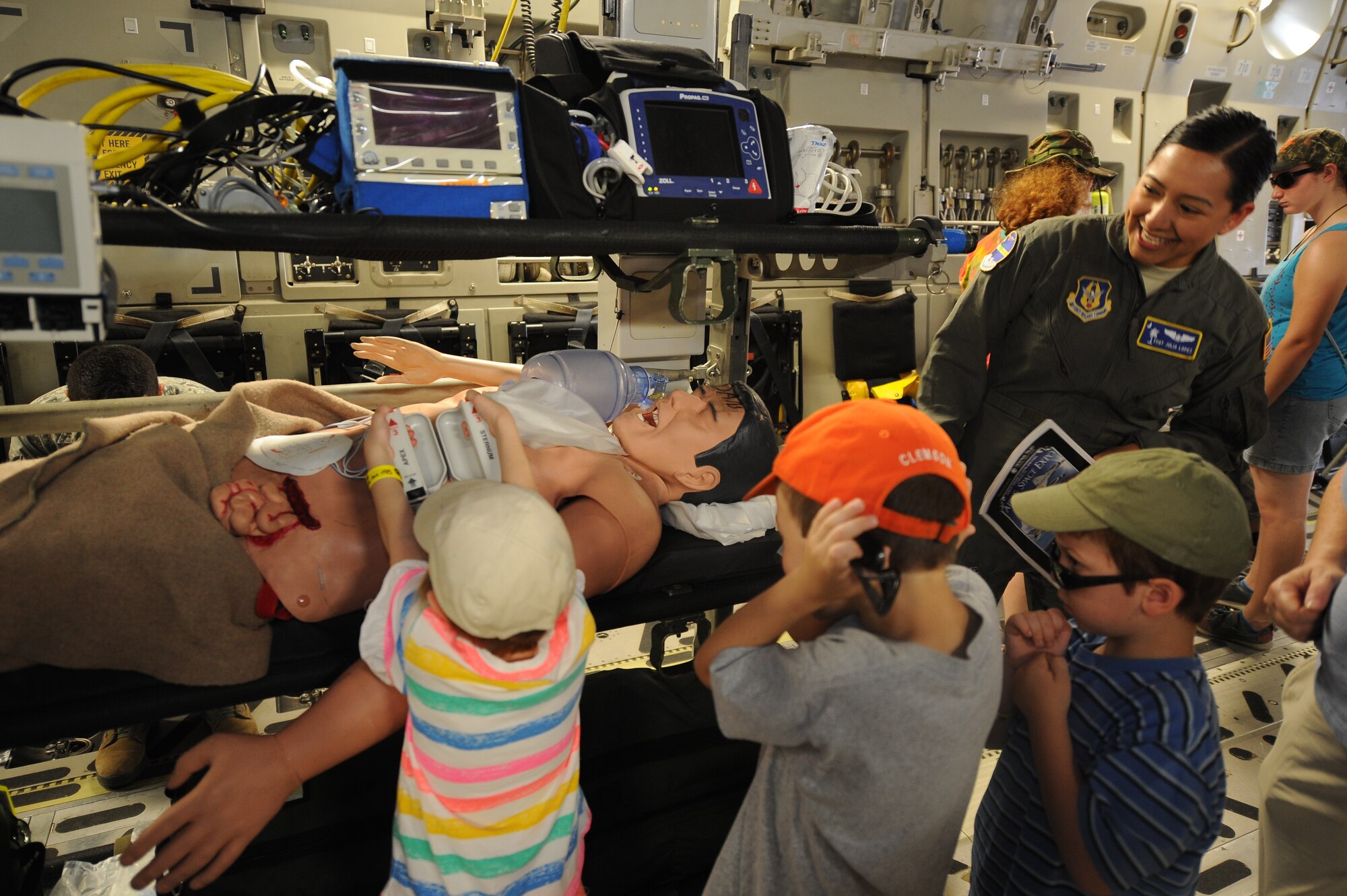 Tech. Sgt. Julia Lopez from the 315th Aeromedical Evacuation Squadron, shows children how defibrillator paddles work while on a C-17 Globemaster III during the Air and Space Expo April 28, 2018, at Joint Base Charleston, S.C.