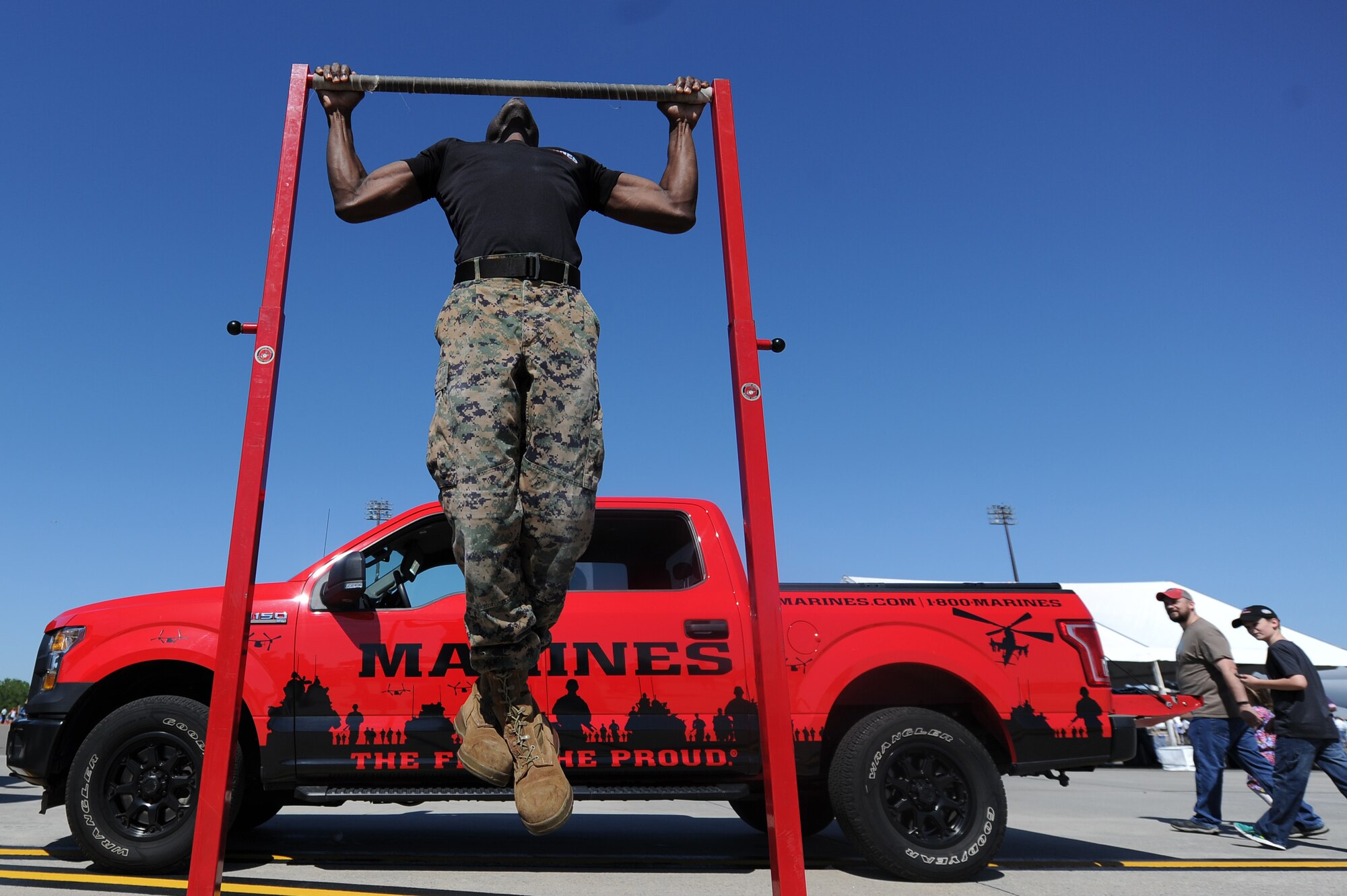 U.S. Marine Corps Sgt. Tony Pressley, Recruiter, performs pull-ups during the Air and Space Expo April 28, 2018, at Joint Base Charleston, S.C. The 2018 Air and Space offered more than 50 demonstrations and displays ranging from Science, Technology, Engineering and Mathematics activities to World War II static display aircraft and aerial demonstration performances highlighting the F-16 Fighting Falcon, C-17 Globemaster III, F-86 Sabre and more. The AeroShell Aerobatics Team headlined the event, wrapping up the full-day show.