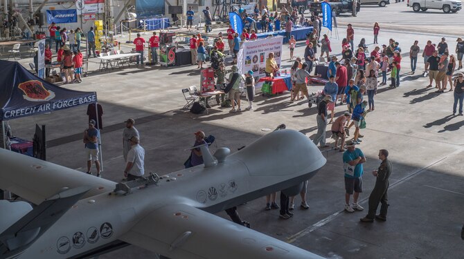 A young child chases down a paper airplane during a paper plane throwing competition at the Joint Base Charleston Air and Space Expo at JB Charleston, S.C.  Apr 28, 2018.