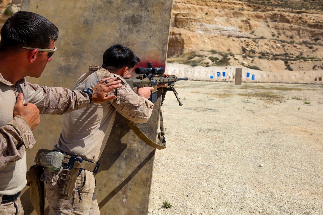 A Marine fires at targets during a shooting event.