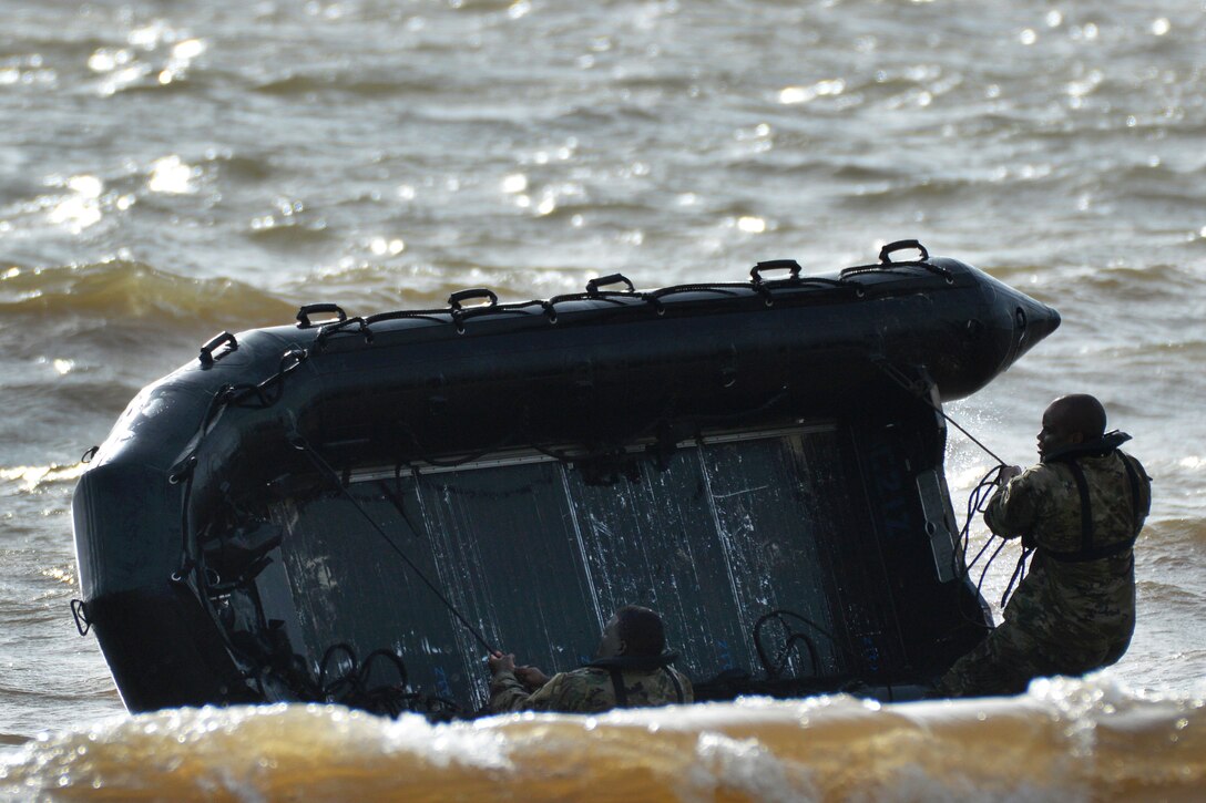 Soldiers intentionally capsize their combat raiding craft.