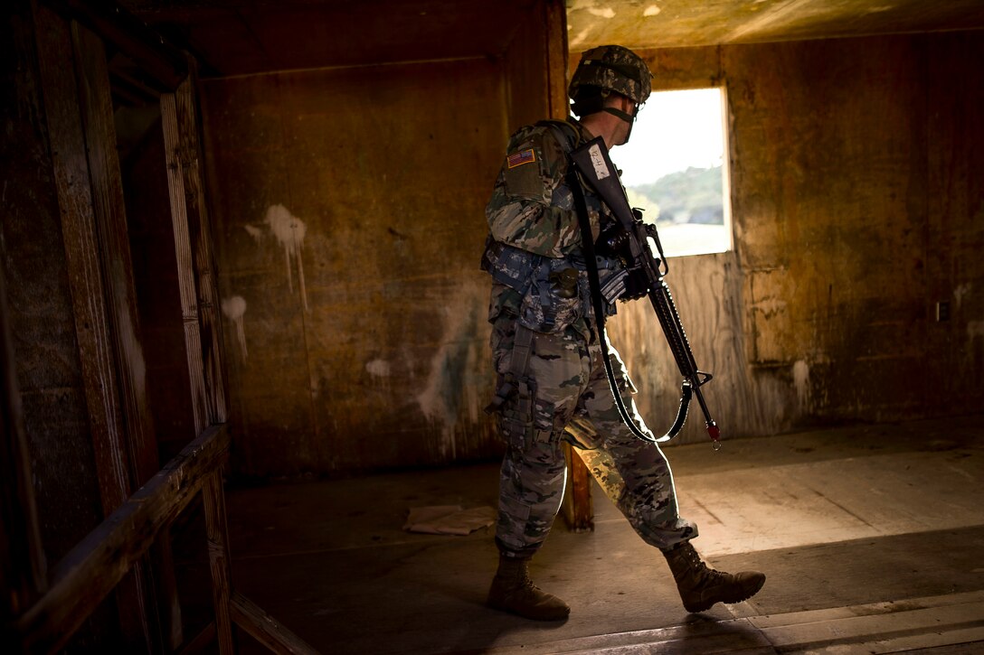 A soldier conducts a building search.
