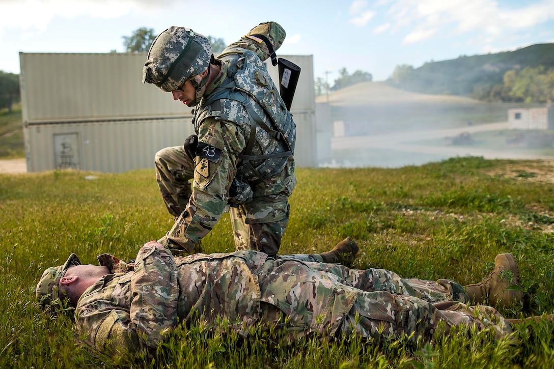 A soldier treats a mock casualty.