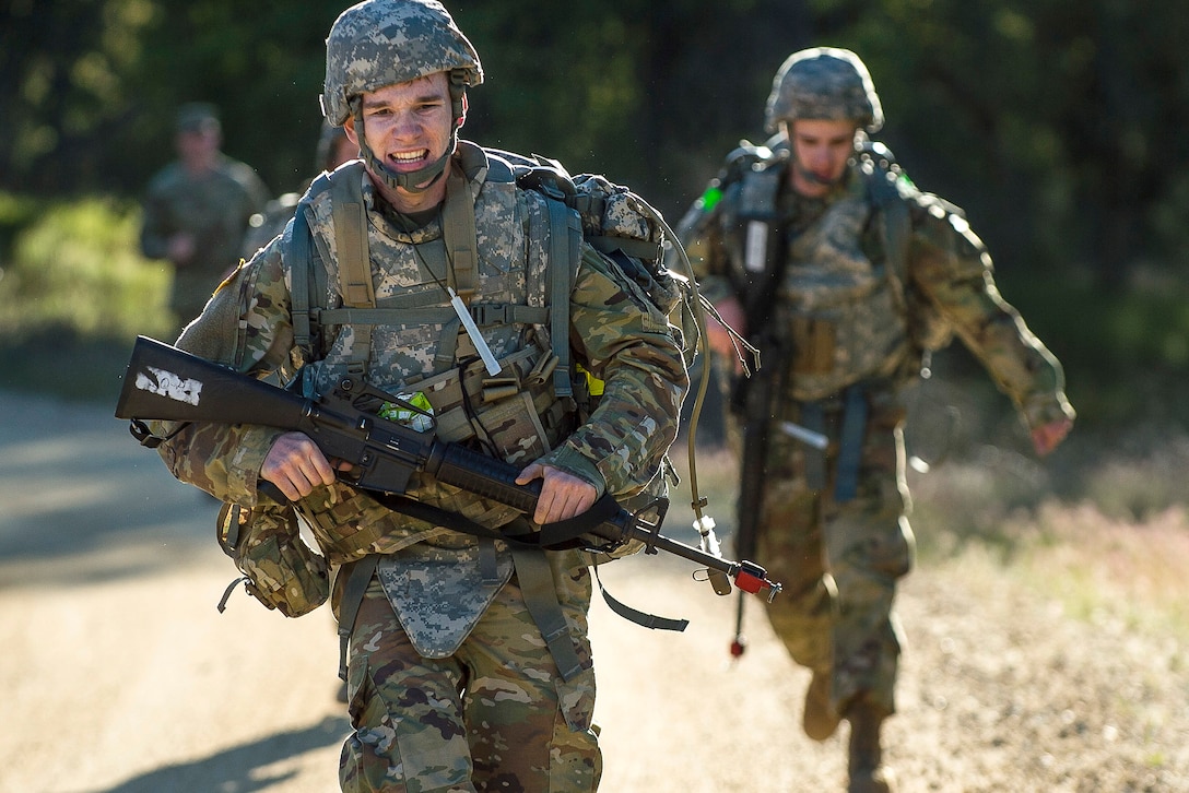 A soldier runs to the finish of a 10-mile ruck march.