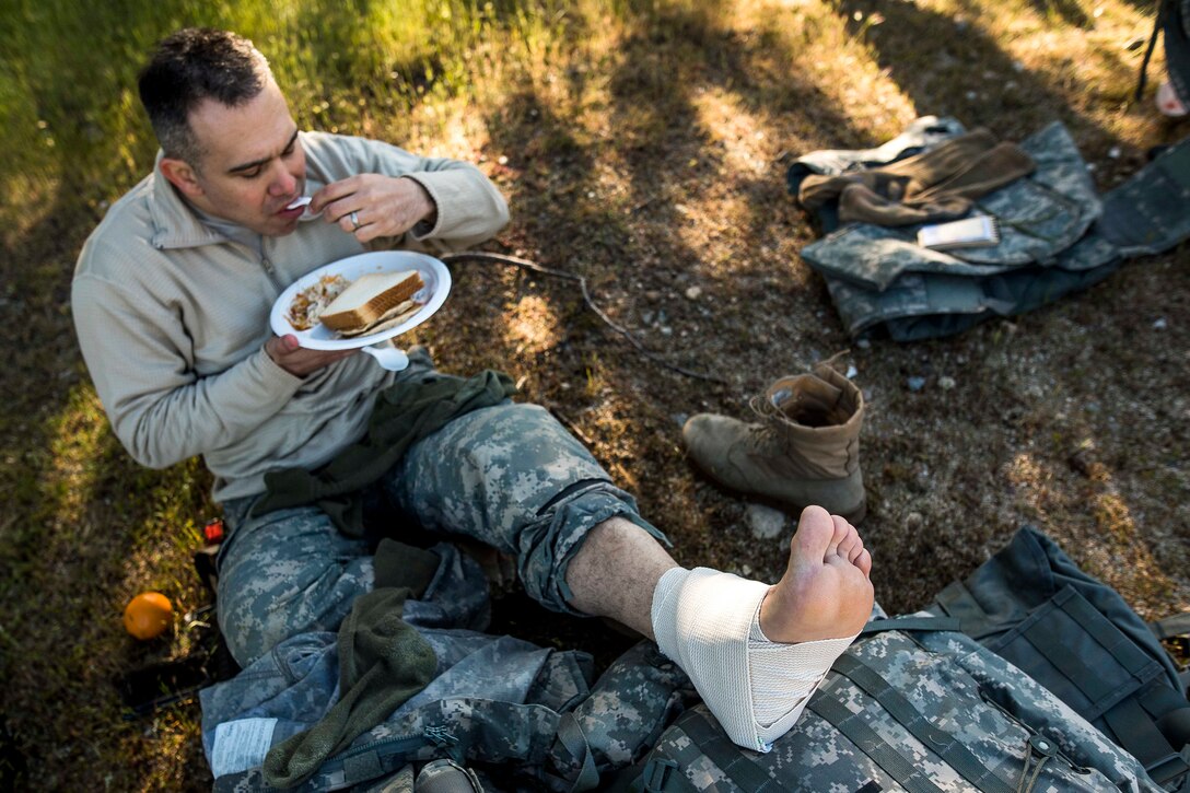 A soldier relaxes eating breakfast.