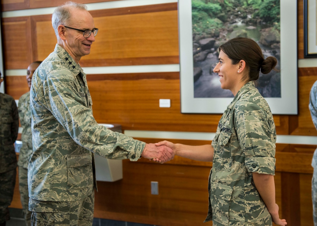 Lt. Gen. Mark A. Ediger, Air Force surgeon general, coins Capt. Casie Leightner, 36th Medical Group physician, during his visit to the Andersen Clinic, April 17, 2018, at Andersen Air Force Base, Guam. Ediger and Cum toured various medical facilities within the group to observe the progress and challenges of AF military treatment facilities. (U.S. Air Force photo by Airman 1st Class Christopher Quail)