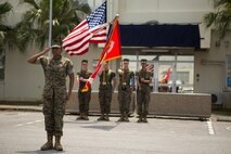 Second Lt. Asia Porcil, adjutant for Headquarters Company, Combat Logistics Regiment 35, 3rd Marine Logistics Group, salutes as the National Anthem is played during the Hauge Hall dedication ceremony April 30, 2018 on Camp Kinser, Okinawa, Japan. Hauge Hall was dedicated in the memory of Cpl. Louis J. Hauge Jr., who received the Medal of Honor for his actions during the Battle of Okinawa. Porcil is a native of Berkeley, California. (U.S. Marine Corps photo by Lance Cpl. Jamin M. Powell)