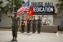 Second Lt. Asia Porcil, adjutant for Headquarters Company, Combat Logistics Regiment 35, 3rd Marine Logistics Group, salutes as the National Anthem is played during the Hauge Hall dedication ceremony April 30, 2018 on Camp Kinser, Okinawa, Japan. Hauge Hall was dedicated in the memory of Cpl. Louis J. Hauge Jr., who received the Medal of Honor for his actions during the Battle of Okinawa. Porcil is a native of Berkeley, California. (U.S. Marine Corps photo by Lance Cpl. Jamin M. Powell)