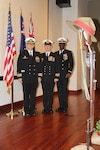 IMAGE: NORFOLK, Va. (April 25, 2018) - Naval Surface Warfare Center Dahlgren Division Dam Neck Activity Commanding Officer Cmdr. Andrew J. Hoffman, Australian exchange officer Lt. Cmdr. Chris Davidson, Royal Australian Navy, and CWO4 Junior Johnson, USN (Ret.), represented the command at the ANZAC Day dawn ceremony at the Gen. Douglas MacArthur Memorial. Behind the contingent are the flags of the United States, Australia and New Zealand, with a 'battlefield cross' and wreaths to commemorate the fallen at right.