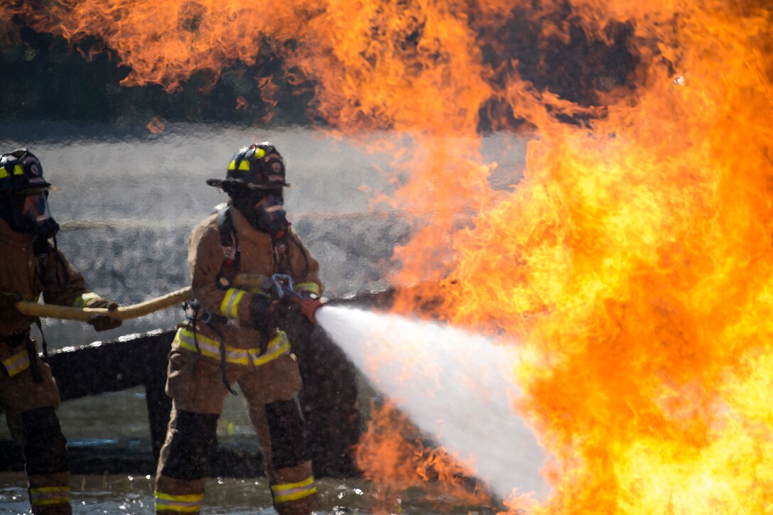 Firefighters from the Valdosta Fire Department (VFD) extinguish an aircraft fire during live-fire training, April 24, 2018, at Moody Air Force Base, Ga. Firefighters from the 23d Civil Engineer Squadron and VFD participated in the training to gain more experience fighting aircraft fires and to work together as a cohesive team while still practicing proper and safe firefighting techniques. (U.S. Air Force photo by Airman Eugene Oliver)