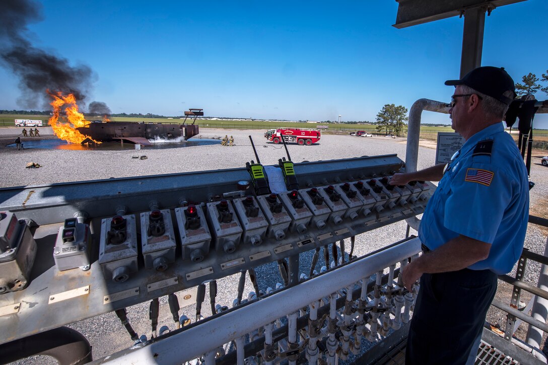 Rodney McKinney, 23d Civil Engineer Squadron (CES) fire crew chief, operates an ignition control panel during live-fire training, April 25, 2018, at Moody Air Force Base, Ga. Firefighters from the 23d CES and Valdosta Fire Department participated in the training to gain more experience fighting aircraft fires and to work together as a cohesive team while still practicing proper and safe firefighting techniques. (U.S. Air Force photo by Airman Eugene Oliver)