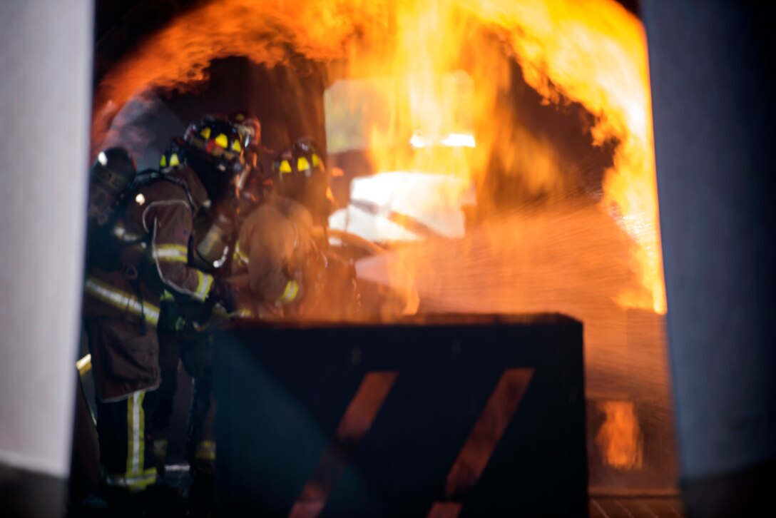 Firefighters from the 23d Civil Engineer Squadron (CES) extinguish an aircraft fire during live-fire training, April 24, 2018, at Moody Air Force Base, Ga.  Firefighters from the 23d CES and Valdosta Fire Department participated in the training to gain more experience fighting aircraft fires and to work together as a cohesive team while still practicing proper and safe firefighting techniques. (U.S. Air Force photo by Airman Eugene Oliver)