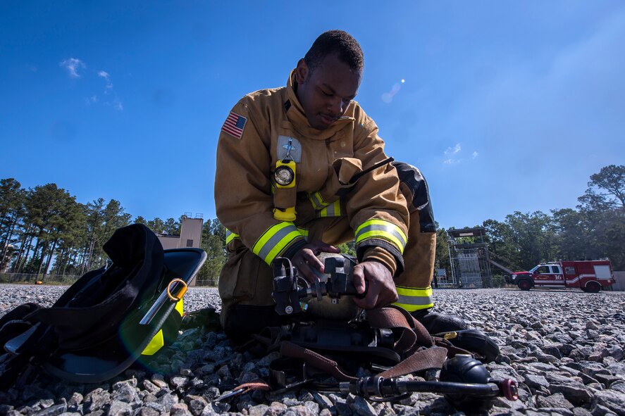 A firefighter from the 23d Civil Engineer Squadron (CES) inspects his oxygen tank following live-fire training, April 25, 2018, at Moody Air Force Base, Ga.  Firefighters from the 23d CES and Valdosta Fire Department participated in the training to gain more experience fighting aircraft fires and to work together as a cohesive team while still practicing proper and safe firefighting techniques. (U.S. Air Force photo by Airman Eugene Oliver)