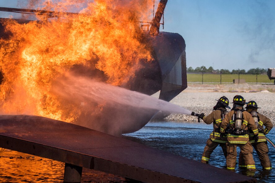 Firefighters from the Valdosta Fire Department (VFD) extinguish an aircraft fire during live-fire training, April 25, 2018, at Moody Air Force Base, Ga. Firefighters from the 23d Civil Engineer Squadron and VFD participated in the training to gain more experience fighting aircraft fires and to work together as a cohesive team while still practicing proper and safe firefighting techniques. (U.S. Air Force photo by Airman Eugene Oliver)