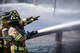 Firefighters from the Valdosta Fire Department (VFD) signal to firefighters from the 23d Civil Engineer Squadron during live-fire training, April 25, 2018, at Moody Air Force Base, Ga.  Firefighters from the 23d Civil Engineer Squadron and VFD participated in the training to gain more experience fighting aircraft fires and to work together as a cohesive team while still practicing proper and safe firefighting techniques. (U.S. Air Force photo by Airman Eugene Oliver)