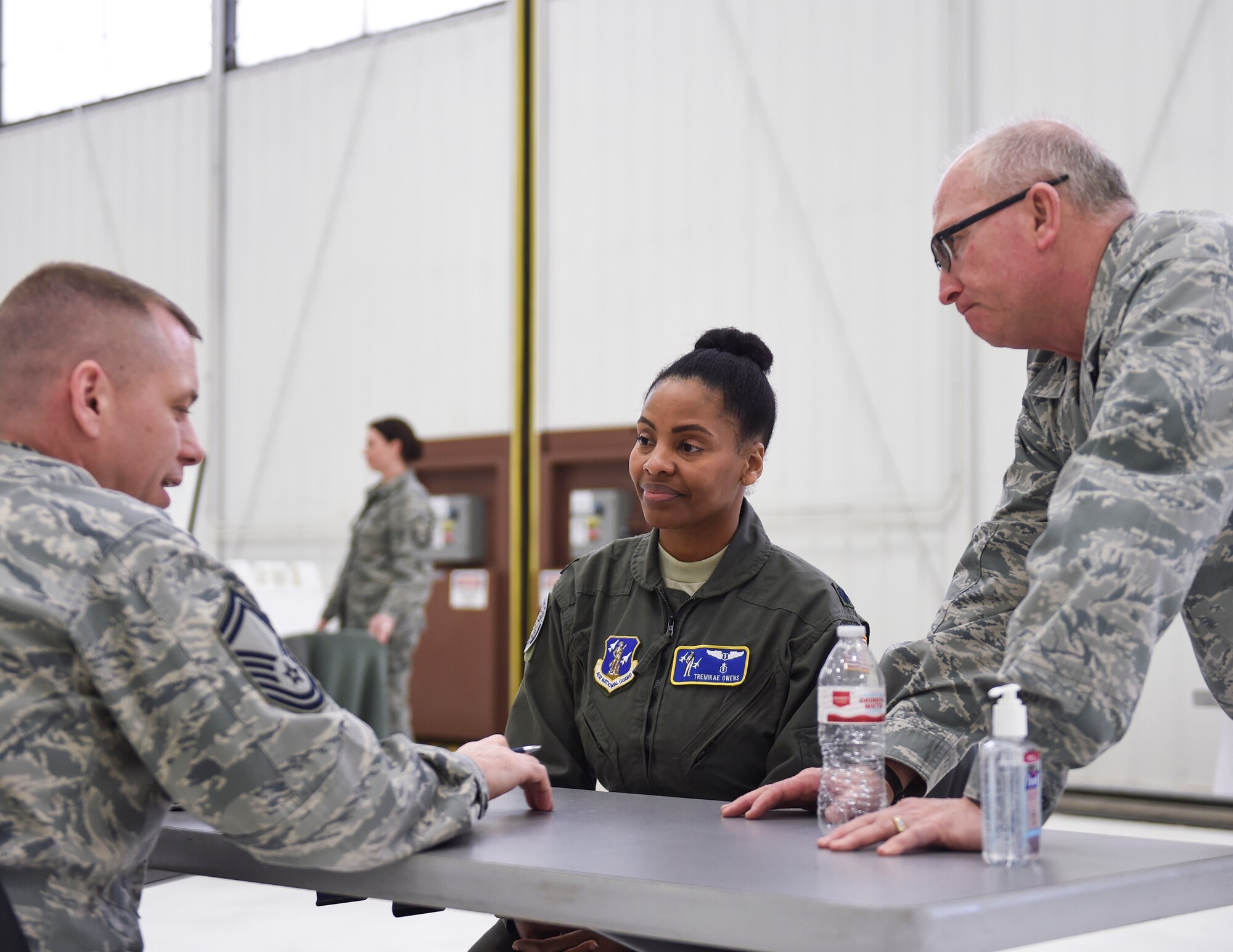 U.S. Air Force Senior Master Sgt. Matthew Woods, 133rd Medical Group, talks to Lt. Col Tremikae Owens, left, branch chief, Medical Case Management, and Col. Charlie Thigpen, left, deputy director for the Office of the Air Surgeon, about what is covered at the health history station in St. Paul, Minn., April 20, 2018.