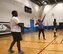At center, Master Sgt. Dawn Williams, 932nd Health Professions Recruiter, serves the volleyball over the net April 26, 2018, at Scott Air Force Base, Ill.  She recruits new medical people into the Air Force Reserve by day at the 932nd Airlift Wing, and also coaches the 932nd Airlift Wing's volunteer volleyball team.  They practice a variety of times and play competitive games against other Scott units on Tuesday and Thursday evenings in the James Gym.  (U.S. Air Force photo by Lt. Col. Stan Paregien)
