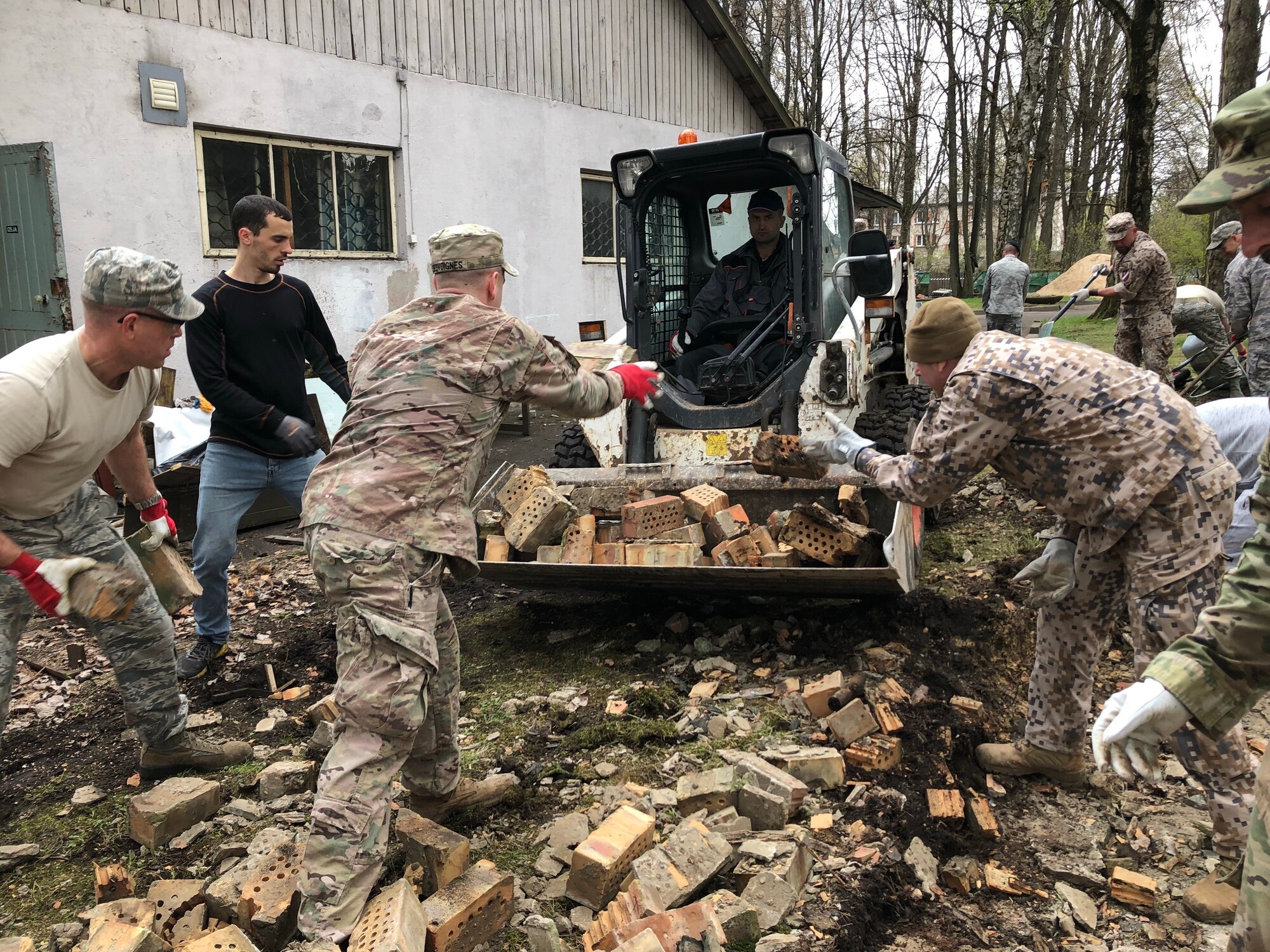 Soldiers and airmen from the Michigan National Guard participate in a volunteer work project at the National Social Care Center, Riga affiliate, as part of Latvia’s “National Clean-up Day,” along with four soldiers from the 407th Civil Affairs Team stationed at Lielvārde Air Base, two personnel from the U.S. Embassy Office of Defense Cooperation, and members of Latvia’s National Guard (Zemessardze) (Michigan National Guard photo by 1st Lt. Andrew Layton/released).