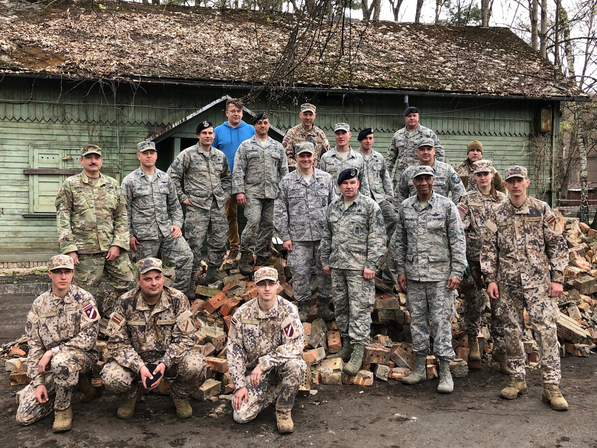 Soldiers and airmen from the Michigan National Guard participate in a volunteer work project at the National Social Care Center, Riga affiliate, as part of Latvia’s “National Clean-up Day,” along with four soldiers from the 407th Civil Affairs Team stationed at Lielvārde Air Base, two personnel from the U.S. Embassy Office of Defense Cooperation, and members of Latvia’s National Guard (Zemessardze) (Michigan National Guard photo by 1st Lt. Andrew Layton/released).