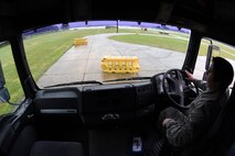A vehicle operator assigned to the 100th Logistic Readiness Squadron navigates a tractor trailer through a driving course at Royal Air Force Lakenheath, England, April 27, 2018. The 48th LRS hosted a ground transportation rodeo where Airmen from both squadrons competed against each other in events to test their driving skills. (U.S. Air Force photo by Senior Airman Eli Chevalier)