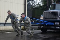 Airmen from the 100th Logistic Readiness Squadron pull a tractor trailer during a ground transportation rodeo at Royal Air Force Lakenheath, England, April 27, 2018. The rodeo offered the opportunity for Airmen from the 48th and 100th LRS the chance to network and compete against their counterparts in a variety of events.(U.S. Air Force photo by Senior Airman Eli Chevalier)