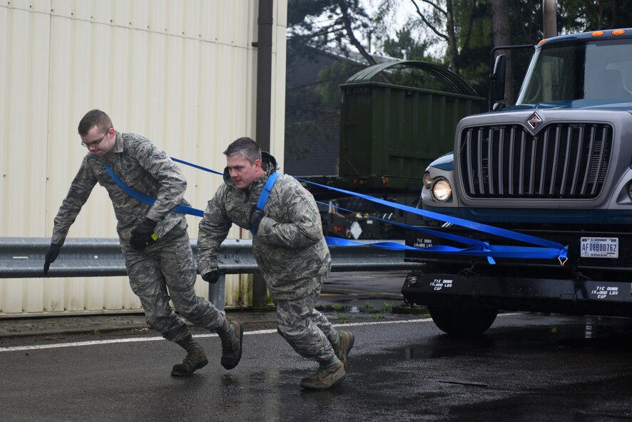 Airmen from the 100th Logistic Readiness Squadron pull a tractor trailer during a ground transportation rodeo at Royal Air Force Lakenheath, England, April 27, 2018. The rodeo offered the opportunity for Airmen from the 48th and 100th LRS the chance to network and compete against their counterparts in a variety of events.(U.S. Air Force photo by Senior Airman Eli Chevalier)