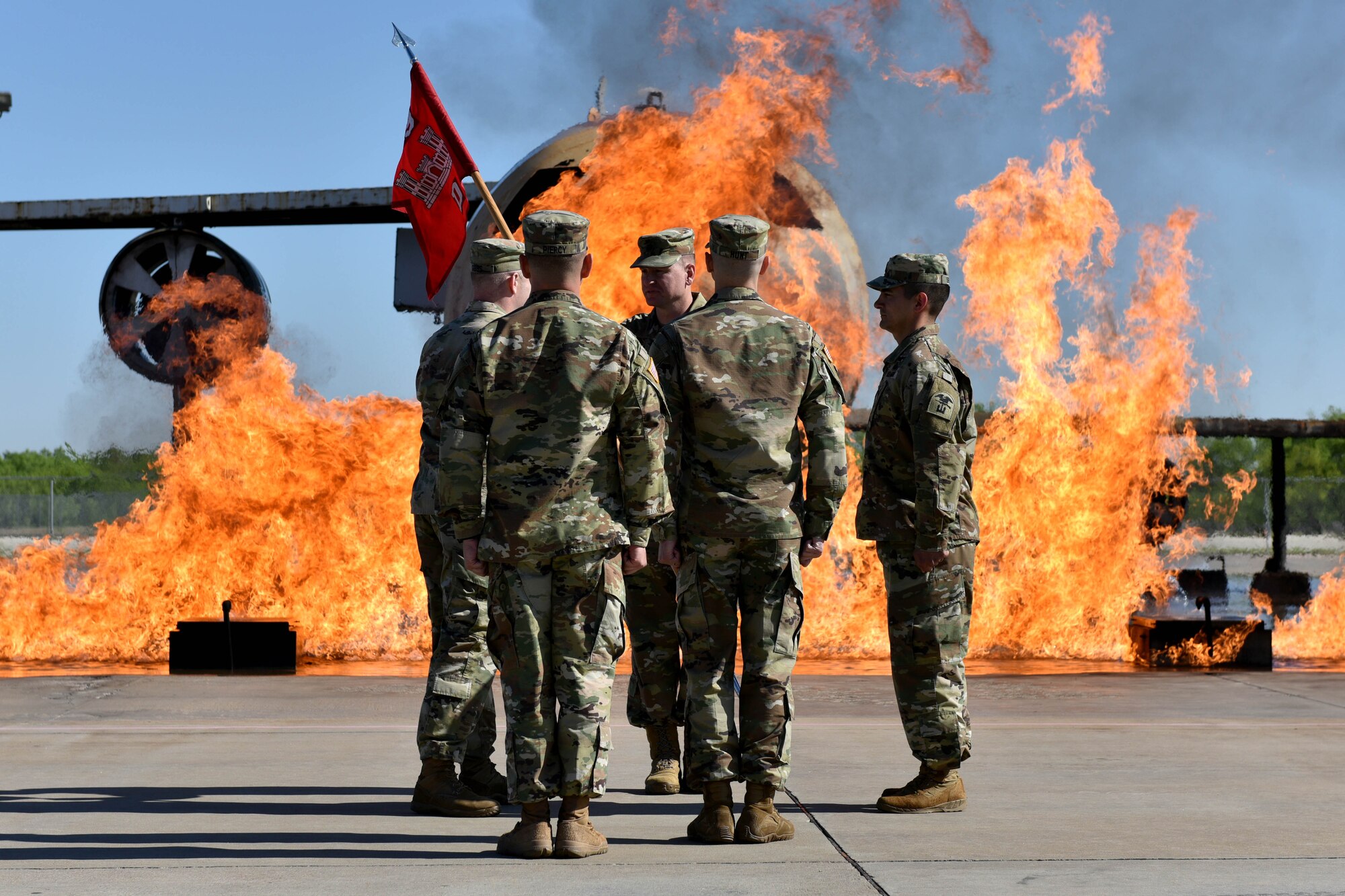 U.S. Army Capt. Christopher Gibbs, Delta Company 169th Engineer Battalion commander, passes the guideon to Lt. Col. Aaron Boher, 169th EN BN commander, on the fire pad at the Louis F. Garland Department of Defense Fire Academy on Goodfellow Air Force Base, Texas, April 27, 2018. Gibbs served as the D CO 169th EN BN commander from 2016 to 2018 (U.S. Air Force photo by Senior Airman Randall Moose/Released)