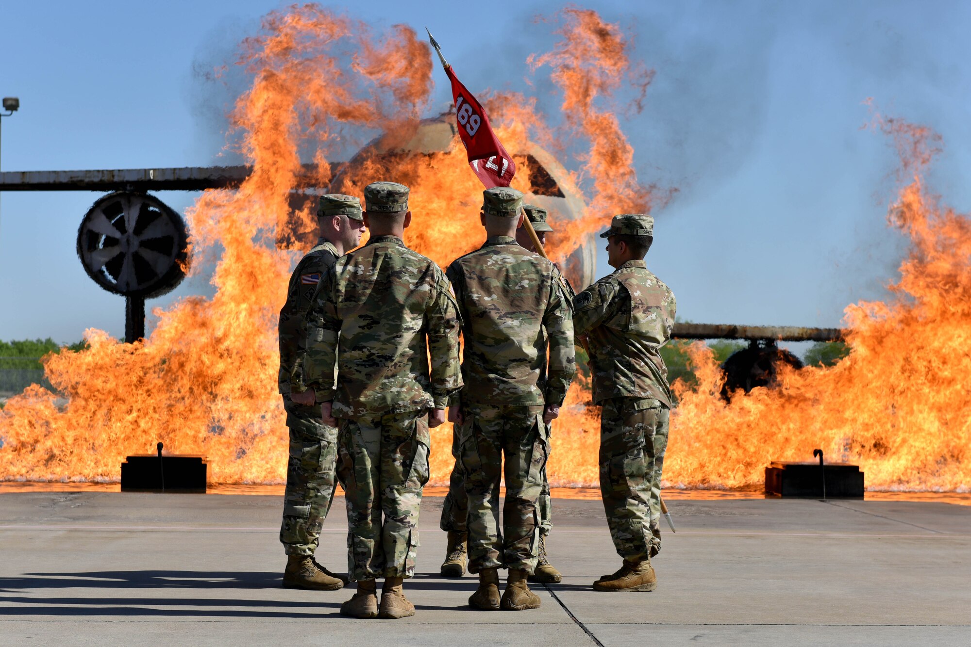 U.S. Army Lt. Col. Aaron Boher, 169th Engineer Battalion commander, passes the guideon to Capt. Brian Sekita, Delta Company 169th EN BN commander, on the fire pad at the Louis F. Garland Department of Defense Fire Academy on Goodfellow Air Force Base, Texas, April 27, 2018. The change of command ceremony is a time honored military tradition that signifies the orderly transfer of authority. (U.S. Air Force photo by Senior Airman Randall Moose/Released)