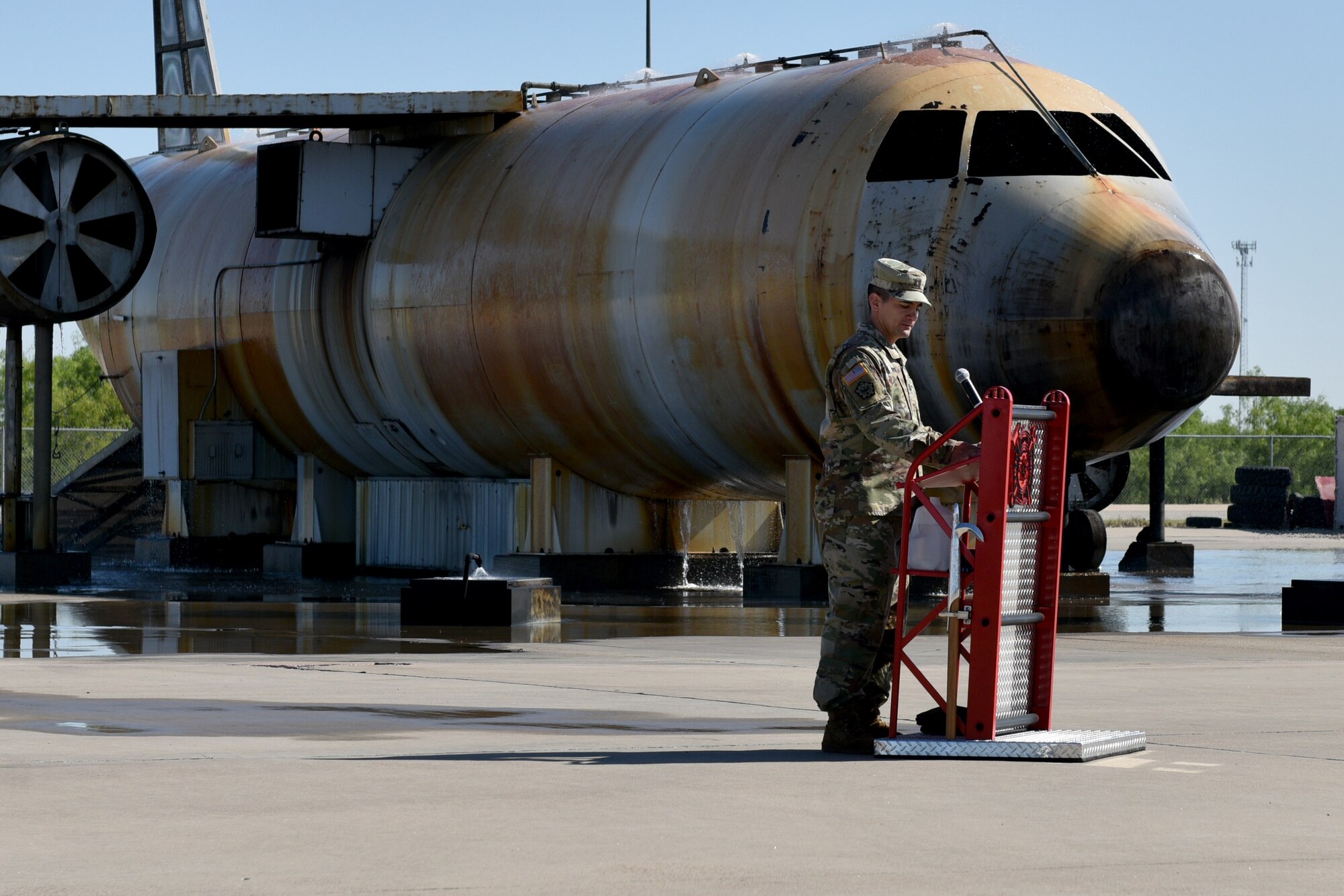 U.S. Army Capt. Brian Sekita, Delta Company 169th Engineer Battalion commander, speaks on the fire pad at the Louis F. Garland Department of Defense Fire Academy on Goodfellow Air Force Base, Texas, April 27, 2018. D CO 169th EN BN, continuously trains Soldiers, Sailors, Marines, Airmen and Coast Guardsmen in firefighting plumbing and power line distribution in preparation for unified land operations, to fight and win our nation’s wars. (U.S. Air Force photo by Senior Airman Randall Moose/Released)