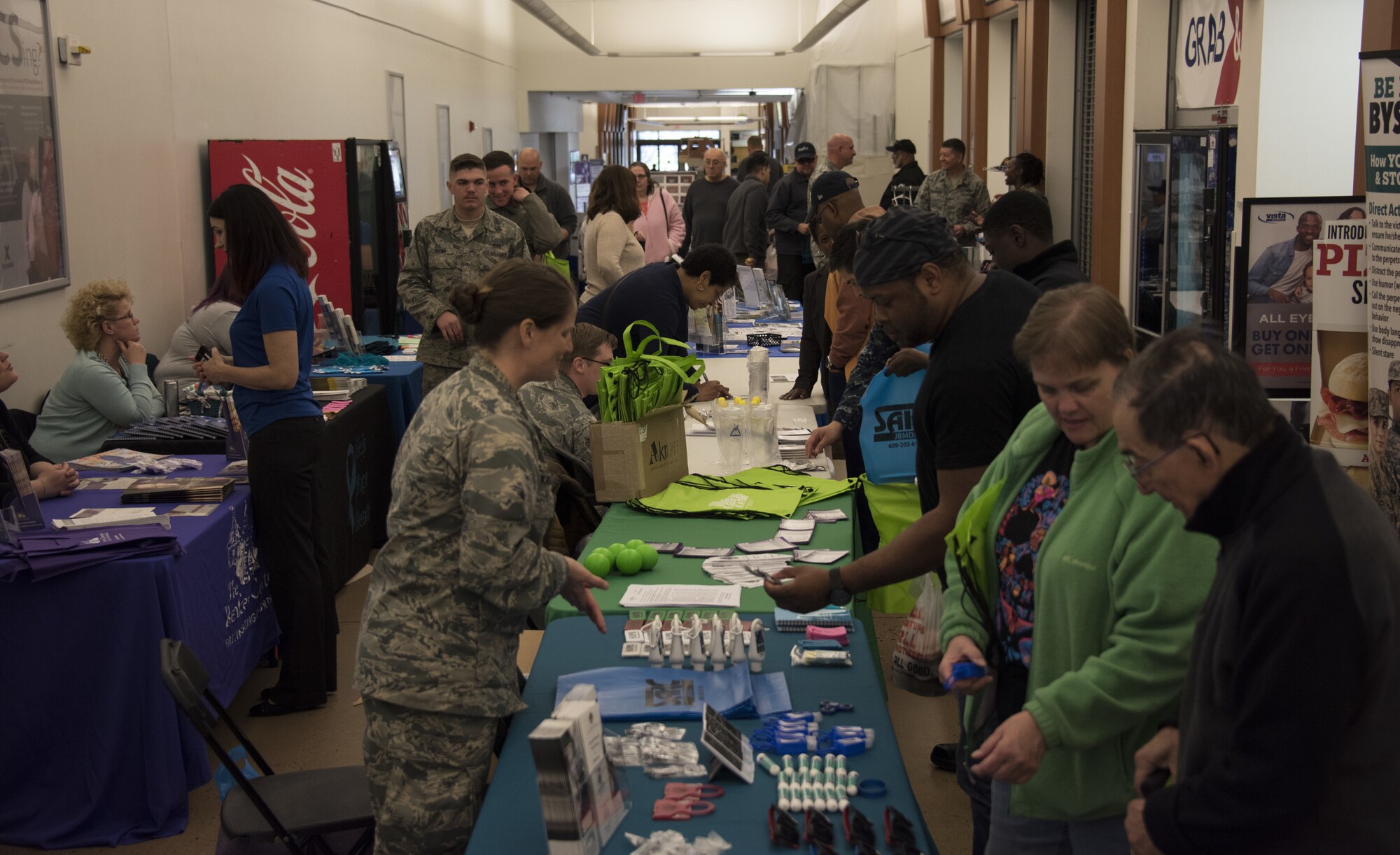 Members of the Joint Base McGuire-Dix-Lakehurst community browse information booths during a Health and Wellness Fair on Joint Base MDL, N.J., April 18, 2018. The event raised awareness of different sexual assault awareness and prevention programs, educating people about the programs and how they can be contacted. (U.S. Air Force photo by Airman Ariel Owings)