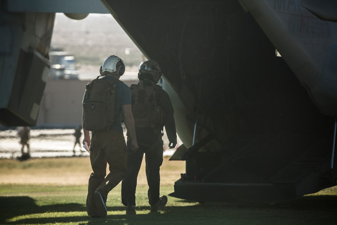 A Marine with Marine Aviation Weapons and Tactics Squadron 1, escorts an acting non-combatant to a Bell Boeing V-22 Osprey for safety during a Non-Combatant Evacuation Operation exercise at Lance Corporal Torrey L. Gray Field aboard the Marine Corps Air Ground Combat Center, Twentynine Palms, Calif., April 20, 2018. The NEO, which is conducted annually, allows for Marines to simulate real-life scenarios where non-combatants need to be evacuated from a potentially hostile area. (U.S. Marine Corps photo by Lance Cpl. Margaret Gale)