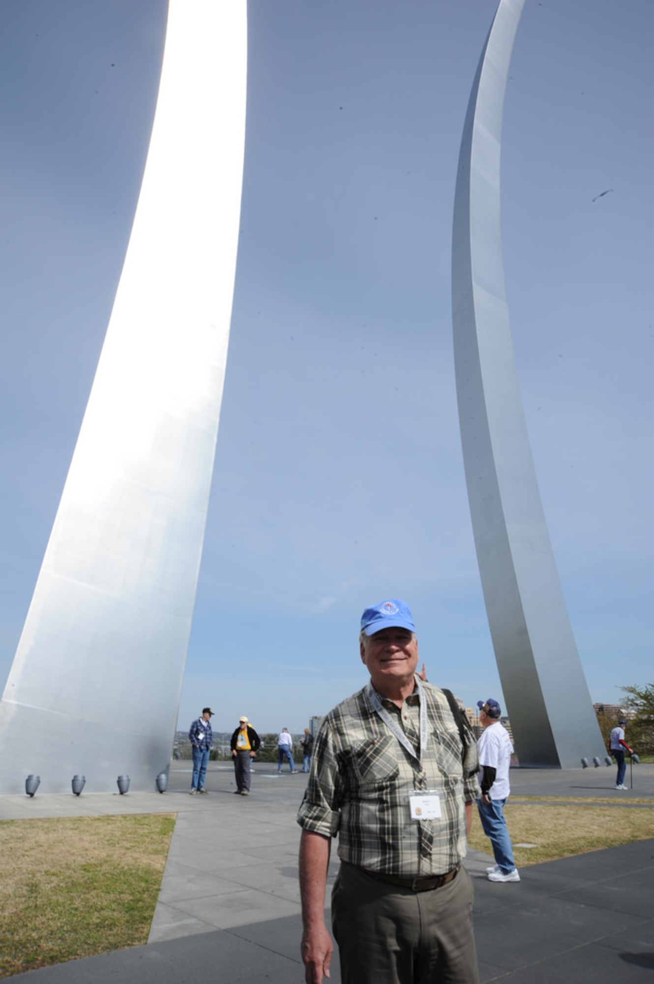 Former program manager Monty Hand, Berlin for Lunch Bunch member who flew the mission from 1986-1991 with two years at Rhein Main and almost two years at U.S. Air Forces in Europe headquarters in Ramstein Air Base, Germany, stands before the Air Force Memorial’s signature spires April 21.