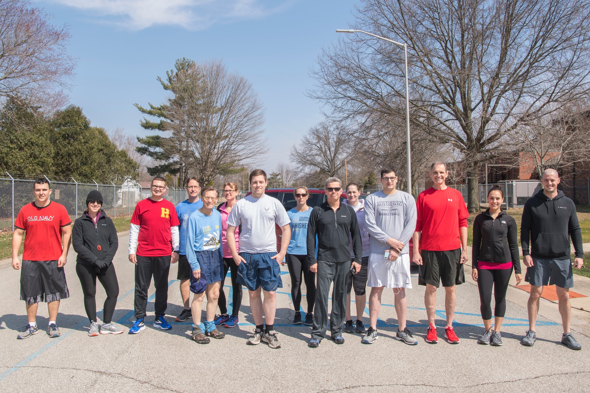Airmen and civilians from the 434th Air Refueling Wing pose for a photo at Grissom Air Reserve Base, Ind., April 12, 2018 prior to a 5k run. The base fitness center hosts a variety of fun runs throughout the year and encourages anyone with access to the base to participate. (U.S. Air Force Photo/Tech. Sgt. Benjamin Mota)