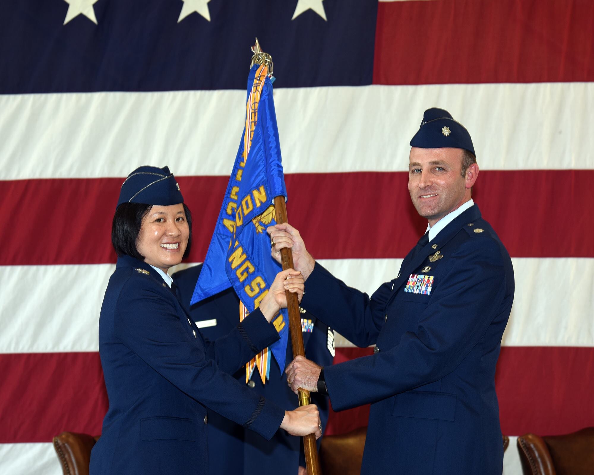 Col. Janette Thode, 340th Flying Training Group deputy commander, presents the 43rd Flying Training Squadron guidon to new squadron commander Lt. Col. Tom McElhinney during the April 27 change of command ceremony at Columbus Air Force Base, Mississippi. (U.S. Air Force photo courtesy of Columbus AFB)