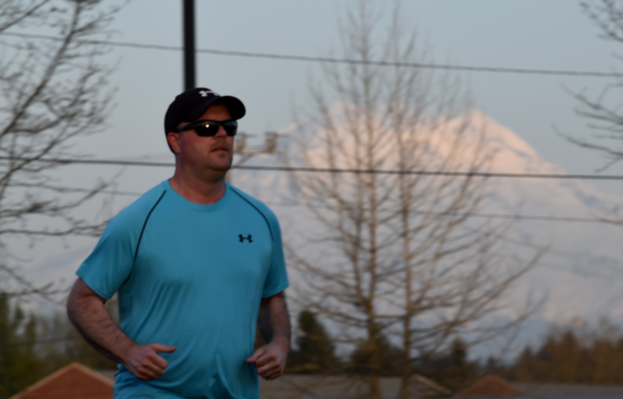 A participant of the 62nd Airlift Wing Sexual Assault Prevention and Response (SAPR) Office’s Take Back the Night 5K walk/run jogs around a track at Joint Base Lewis-McChord, Wash., April 25, 2018. The SAPR office is holding several events in the month of April for Sexual Assault Awareness and Prevention Month. (U.S. Air Force photo by Senior Airman Tryphena Mayhugh)
