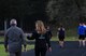 Heather Van Mill, right, 62nd Airlift Wing Sexual Assault Response Coordinator (SARC)/Sexual Assault Prevention and Response (SAPR) program manager, and other participants walk or run around a track for the SAPR/SARC Take Back the Night 5K at Joint Base Lewis-McChord, Wash., April 25, 2018. April is Sexual Assault Awareness and Prevention Month and the SARC/SAPR office held the 5K to raise awareness about sexual assault. (U.S. Air Force photo by Senior Airman Tryphena Mayhugh)