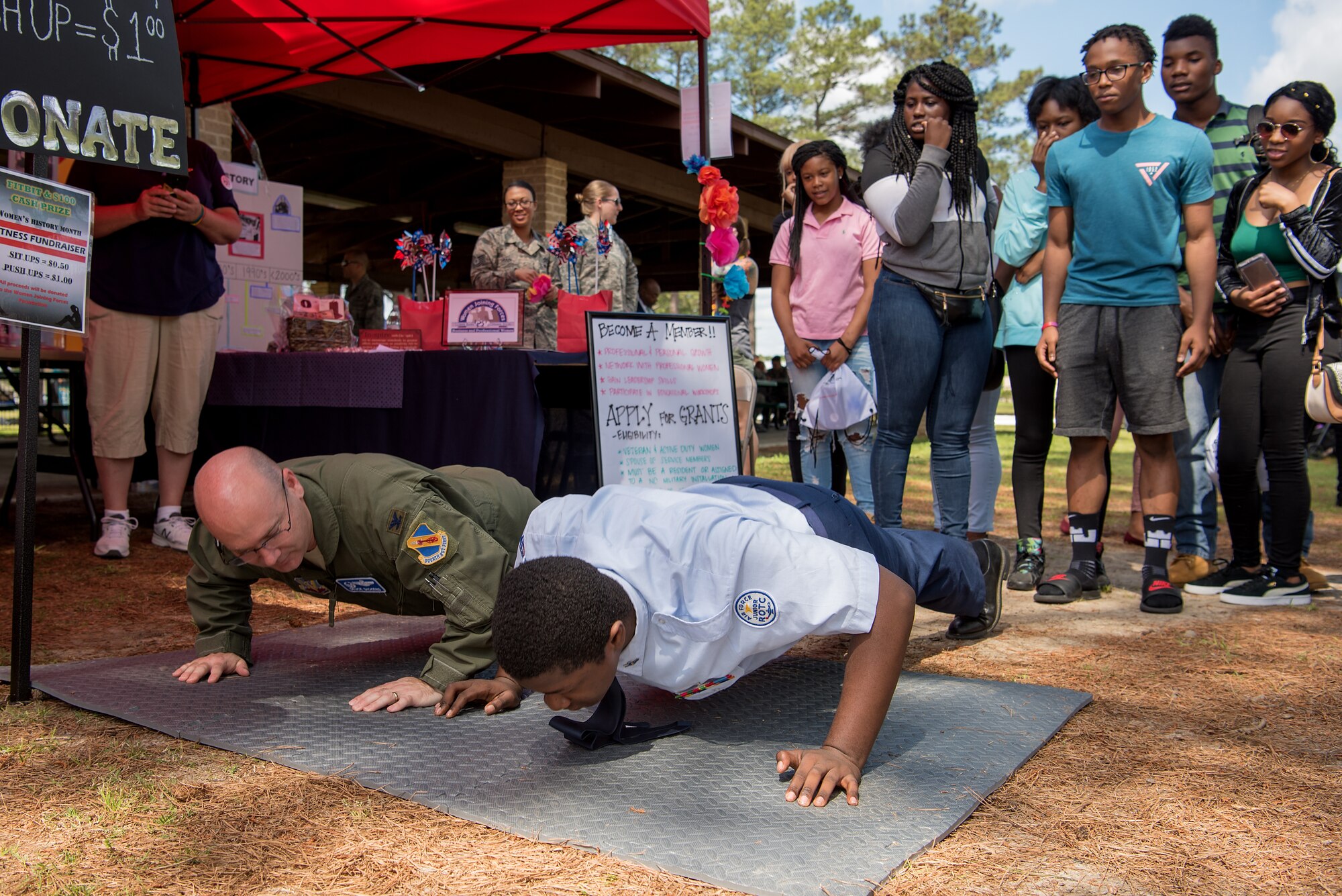Col. Richard Dickens, 4th Operations Group commander, challenges an Air Force Junior ROTC cadet to a push-up challenge during a Diversity Day celebration, April 27, 2018, at Seymour Johnson Air Force Base, North Carolina.